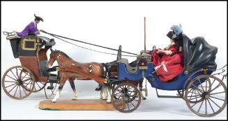 Two 20th century decorative horse and traps both with ceramic horses the first with a lady at the