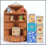 A collection of Paul Cardew collectable miniature teapots together with a Paul Cardew pine display