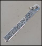 A silver metal metamorphic Masonic symbol necklace pendant in the form of a Masonic square and