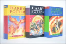 A group of three J K Rowling Harry Potter hard back 1st edition books to include ' Harry Potter and
