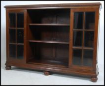 An Edwardian mahogany library bookcase cabinet raised on stub bun feet with gadrooned plinth.