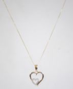 A 9ct gold heart pendant necklace and chain. The fine linked chain with interlocking heart pendants.