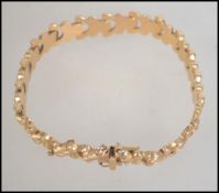 An 18ct gold link bracelet stamped 750 with deployment clasp and safety chain, gross weight 14.3g.