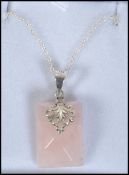A ladies silver and rose quartz pendant and necklace chain.