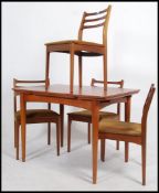A retro 1970's Danish inspired teak wood refectory draw leaf dining table together with the 4