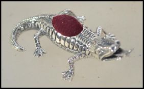 A silver pin cushion in the form of a Komono dragon having red velour cushion atop. Total weight 13.