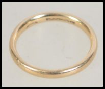 A hallmarked 9ct gold band ring . Size P.5. Weight 2.7g. .