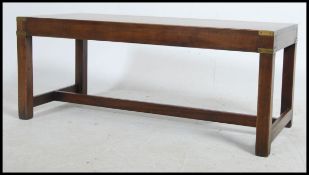 A good 20th century mahogany and brass campaign coffee - occasional table being raised on squared
