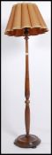 A good mid 20th century oak standard lamp having a turned column raised on a circular base with