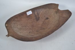 A Melanasian wooden bowl of fish form having shell eye and the fins with typical chased decoration