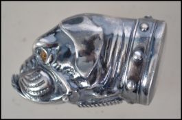 A silver plated vesta case in the form of a dogs head ( boxer dog ) having glass eyes.