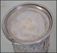 A late Victorian silver hallmarked cylindrical string box with embossed rococo decoration,