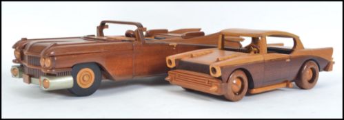 An impressive hand carved and crafted wooden American 1950's car being a convertible together with
