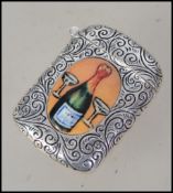 A silver plated rococo chased vesta with hinged top and pictorial of a maiden and a champagne
