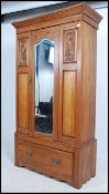 An Edwardian satin walnut single wardrobe being raised on a plinth drawer base with mirror glass