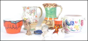 A collection of ceramics to include Poole Pottery, Decora pottery art deco jug,