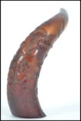 A 20th century well carved ox horn depicting elders, temples,