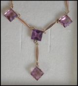A 9ct gold and amethyst necklace with amethyst drop pendant and lobster claw clasp.