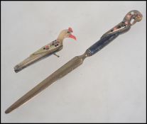 A vintage early 20th century letter opener and penknife set modelled as birds.