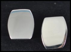 A pair of gentlemans silver cufflinks having plain cartouche panels being complete in the