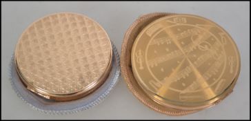 Two 1930's ladies powder compacts with original felt cases.