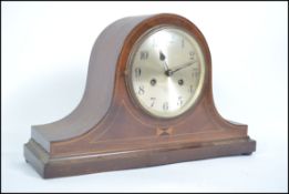 A 20th century Edwardian mahogany inlaid Napoleon mantel clock with inlay detail to front.