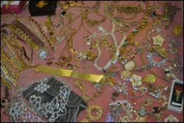 An extensive collection of costume jewellery to include brooches, bracelets, bangles etc.