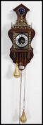 A 20th century mahogany Dutch chain clock with chain and weights having cherub / putti crest and