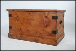 A good Victorian pine blanket box having ebonised cast metal bracket work with carry handles to the