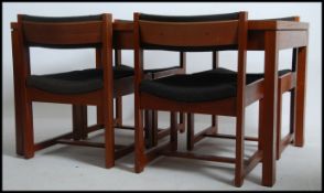A 1960's teak wood Danish influence dining table and 4 chairs - suite.