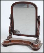 A Victorian 19th century large mahogany toilet swing mirror raised on shaped arms and plinth base.