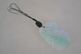 A white jade pendant with green stone bead with platted string bale with carved serpent,