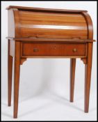 An antique style cherrywood ladies Bonheur De Jour writing table desk having a roll top tambour