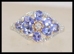 A hallmarked 14ct gold amethyst and diamond cluster ring. Hallmarked Birmingham. Size P.5. Weight 3.