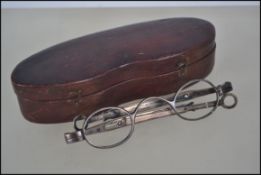 A pair of silver hallmarked glasses within the original leather case. Hallmarks rubbed.