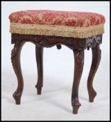 A 20th century rococo mahogany rise and fall piano stool having overstuffed chenille upholstered
