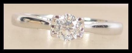 An 18ct white gold and diamond solitaire ring. Marked Forever within the shank with a diamond set O.
