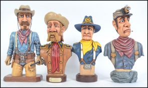 A collection of 4 impressive hand carved and crafted wooden figurines of American Cowboy,