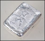 A sterling silver gentlemans gold ball marker case with scene of golfer in relief to the hinged top.