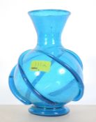 An Islamic blue glass vase with embellished swirl decoration to the bulbous body having waisted and