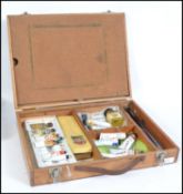 A 20th cenutry wooden cased artists box containing many accessories to i include paints,