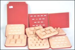 A collection of retro 1960's jewellery display pads, all with red vinyl backing,