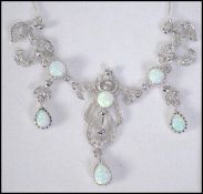 A very pretty silver cz and opal adorned necklace in the Art Nouveau style set to a snake linked