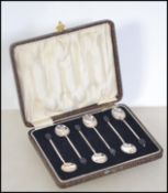 A cased set of six silver hallmarked coffee bean spoons with Birmingham assay mark,