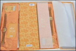 A collection of original Swatch watches in the original packaging boxes and the Scarves ( see