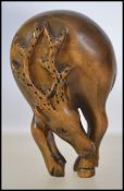 A 20th century carved wooden Japanese netsuke in the form of a deer.