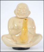 A retro Tupperware 1984 Tim Mitchinson ceramic teapot in the form of a seated Buddha teapot the