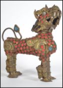 An unusual Chinese scent bottle / scroll holder in the form of a temple dog constructed from gilt