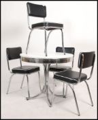 A retro type chrome and black vinyl American diner style dining table and 4 chairs.