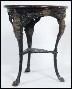 A Victorian cast iron Britannia pub table tavern table having a later circular oak table top